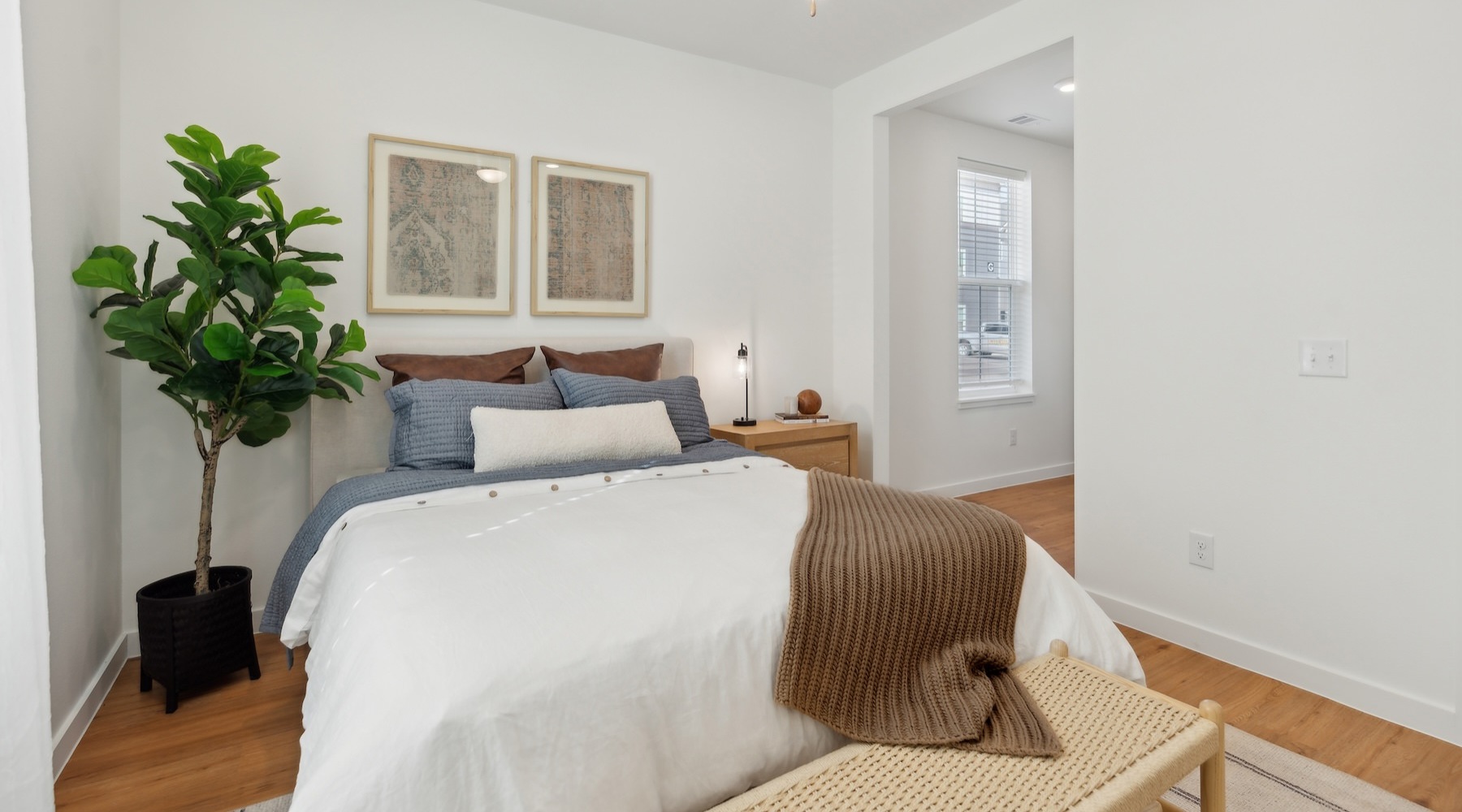 a bedroom with a bed and a plant