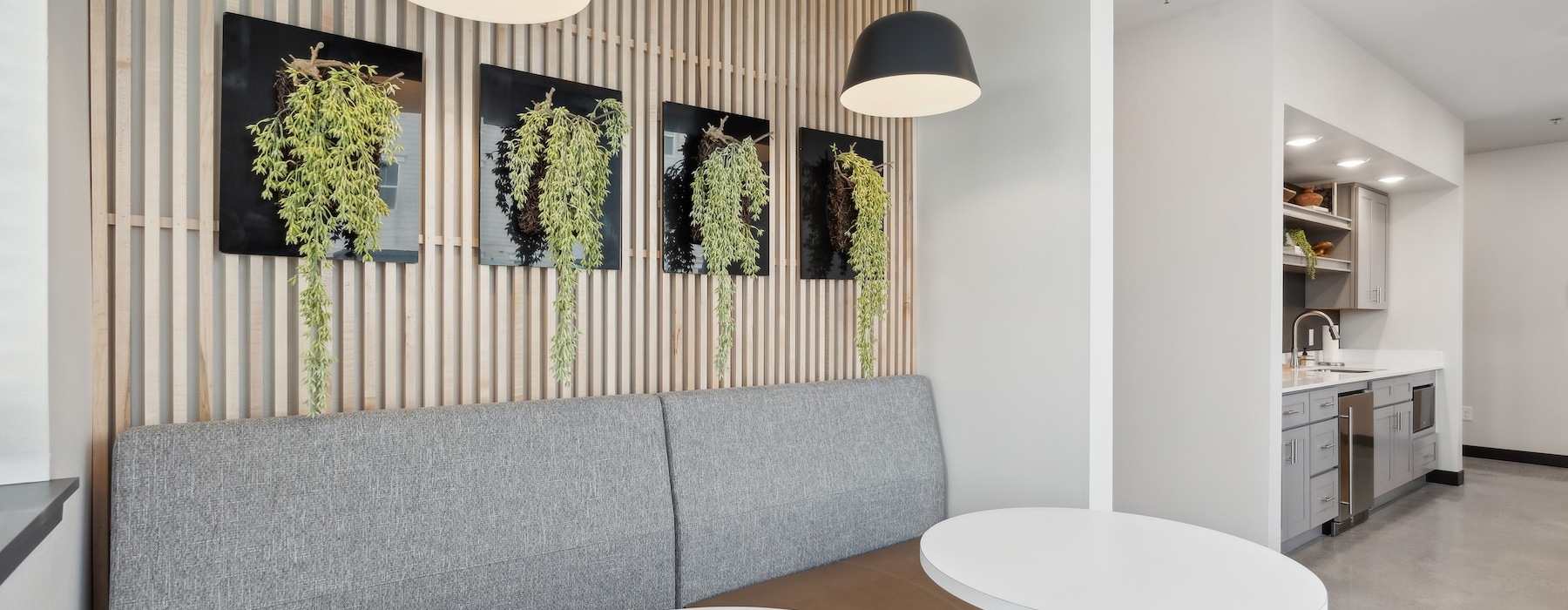 a clubroom lounge area with a couch and tables