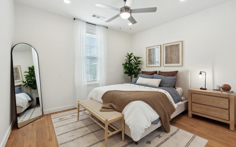 a bedroom with a bed and a fan